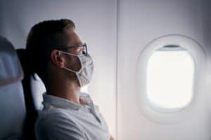 passenger with protective face mask in airplane 2021 09 03 16 06 58 utc